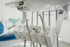 A dental lab technician working on a digital wax-up model.