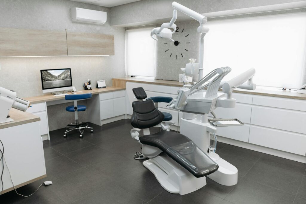 A dentist examining a patient's teeth with dental tools.