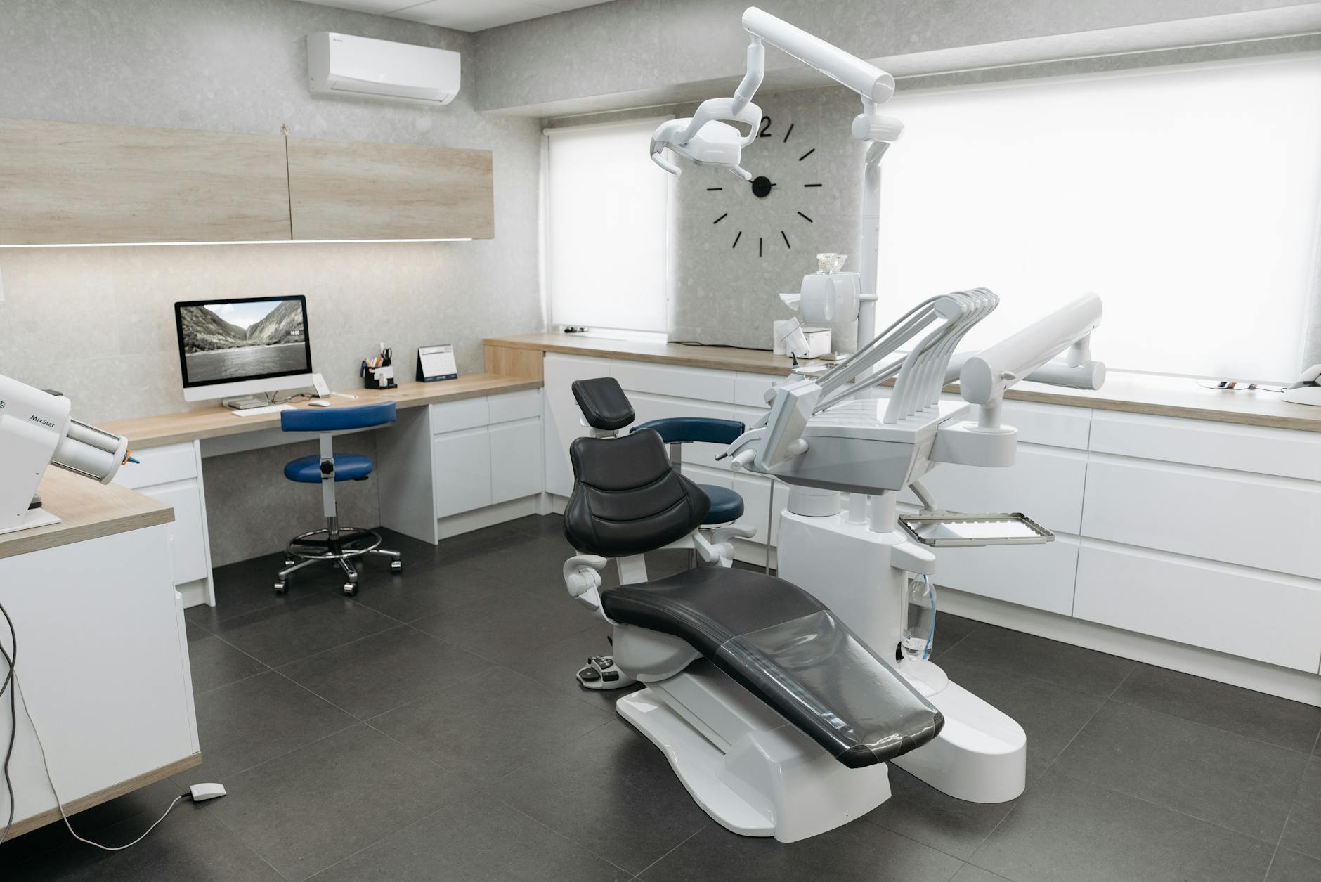A dentist examining a patient's teeth with dental tools.